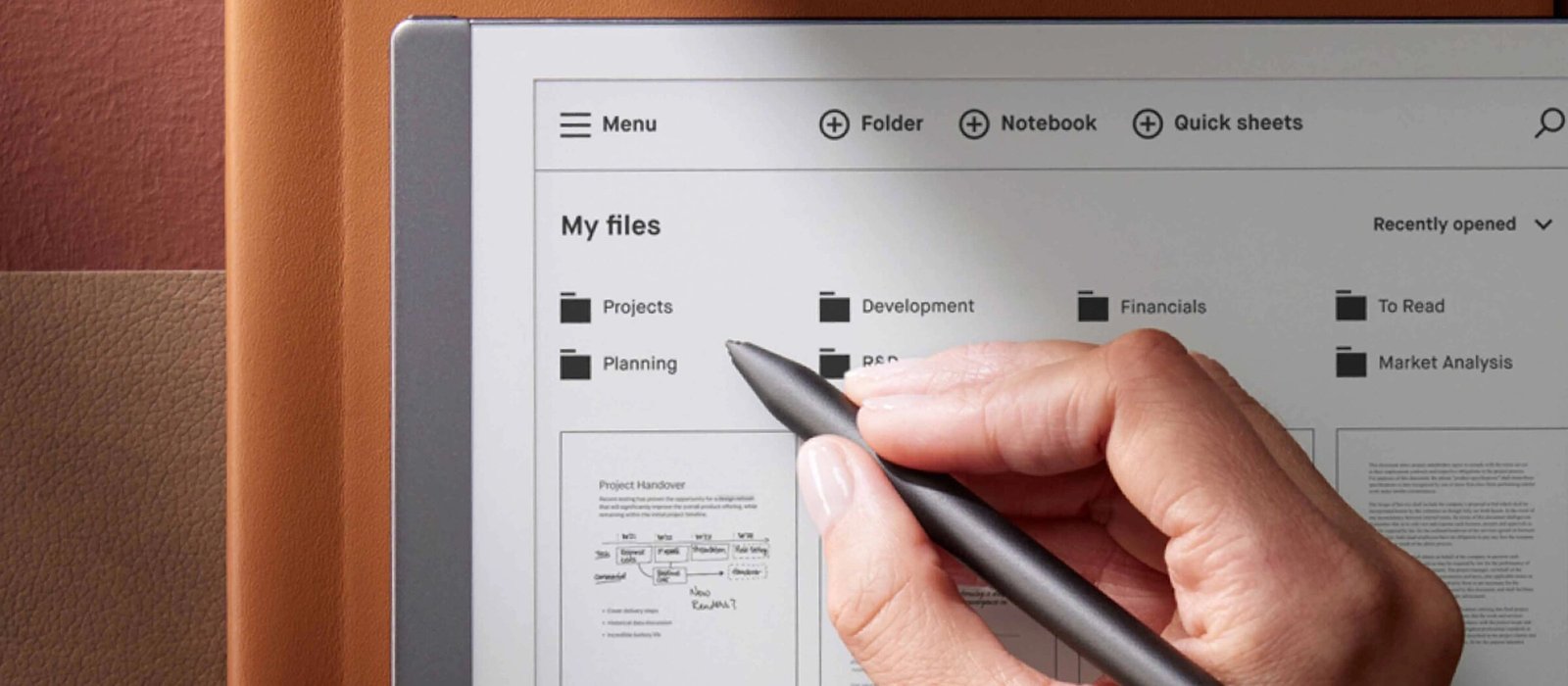 Hand using a stylus on a tablet